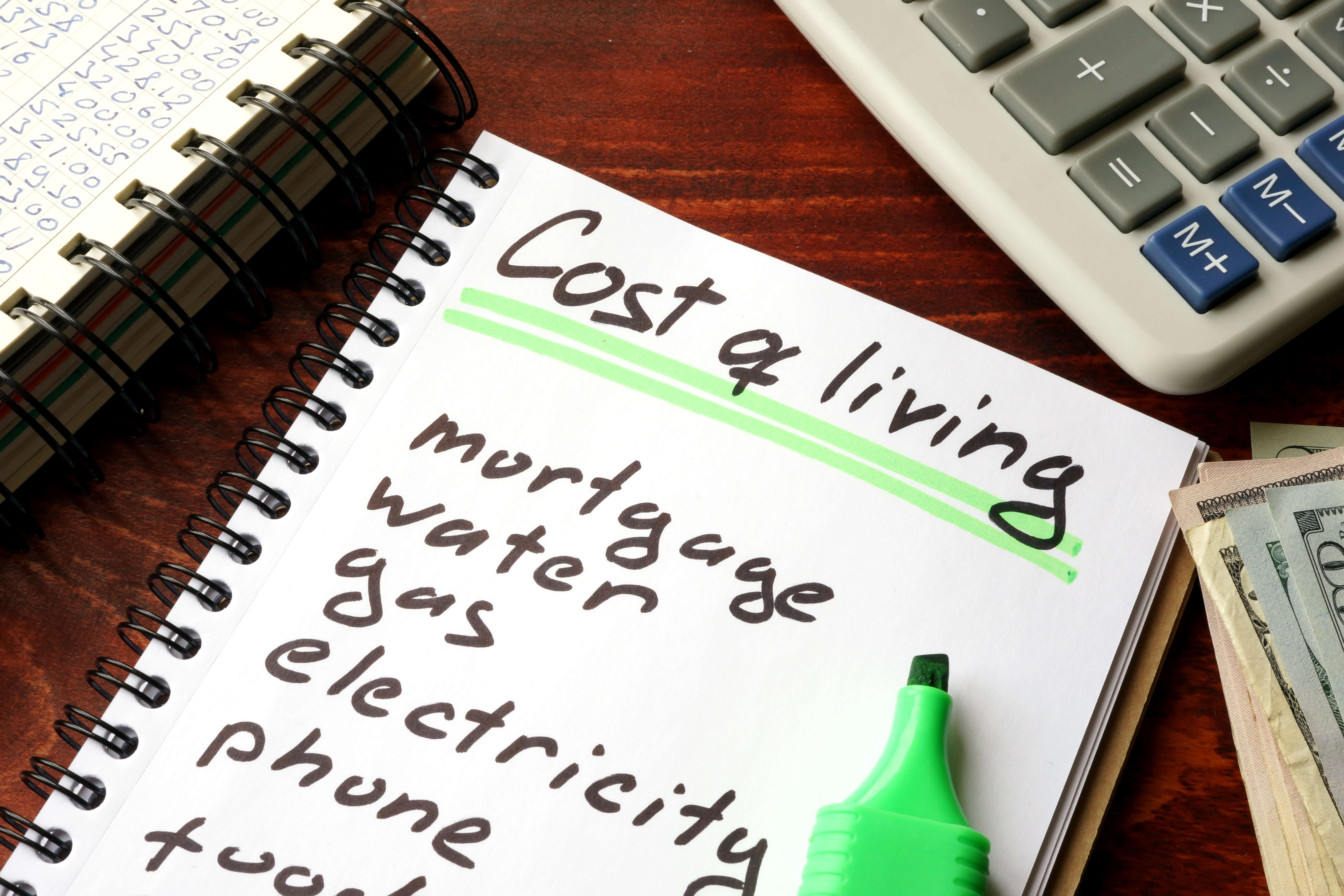 Notebook with a list of cost of living items and bills Notebook with a list of cost of living items and bills