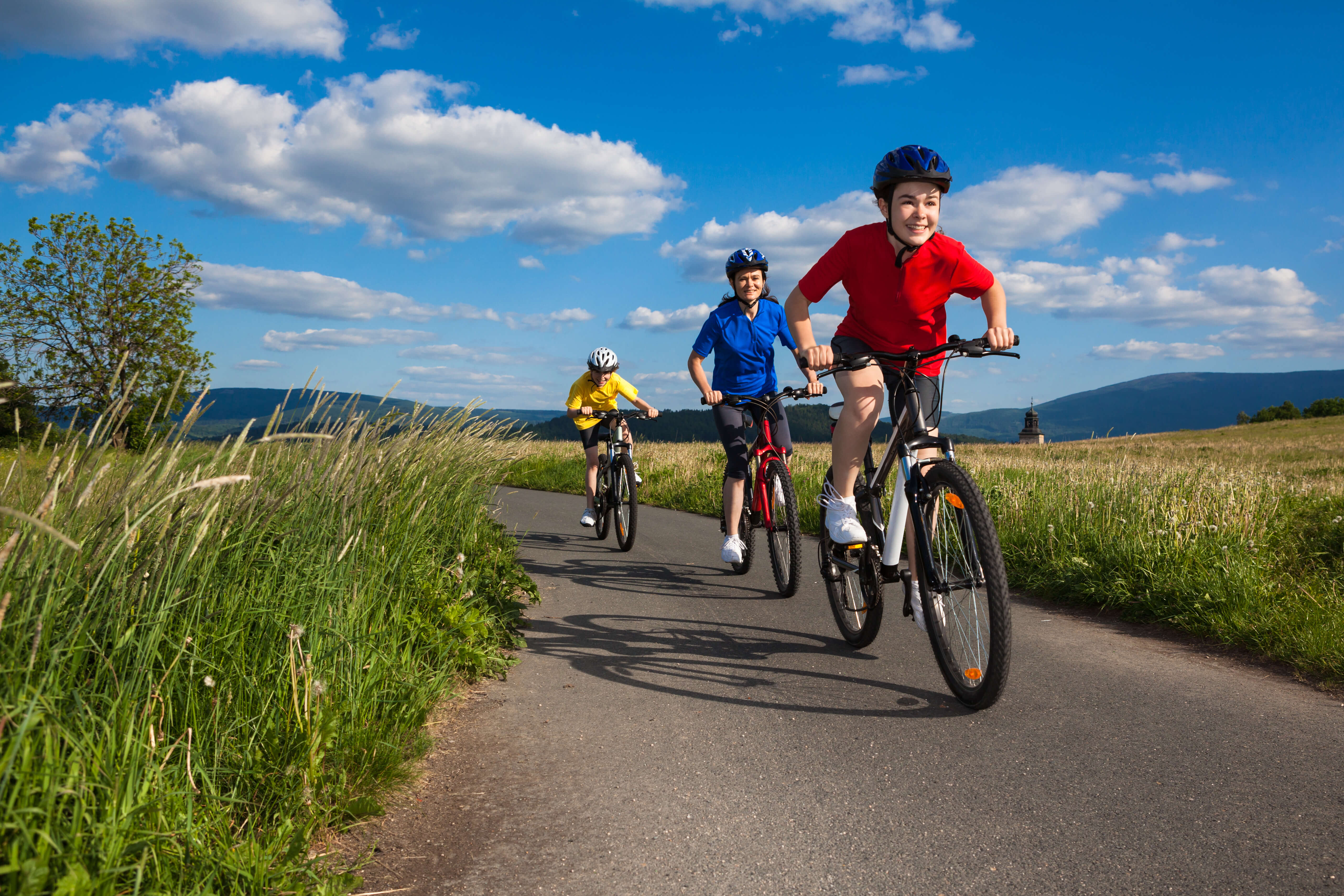 three children riding bicycles in outdoors