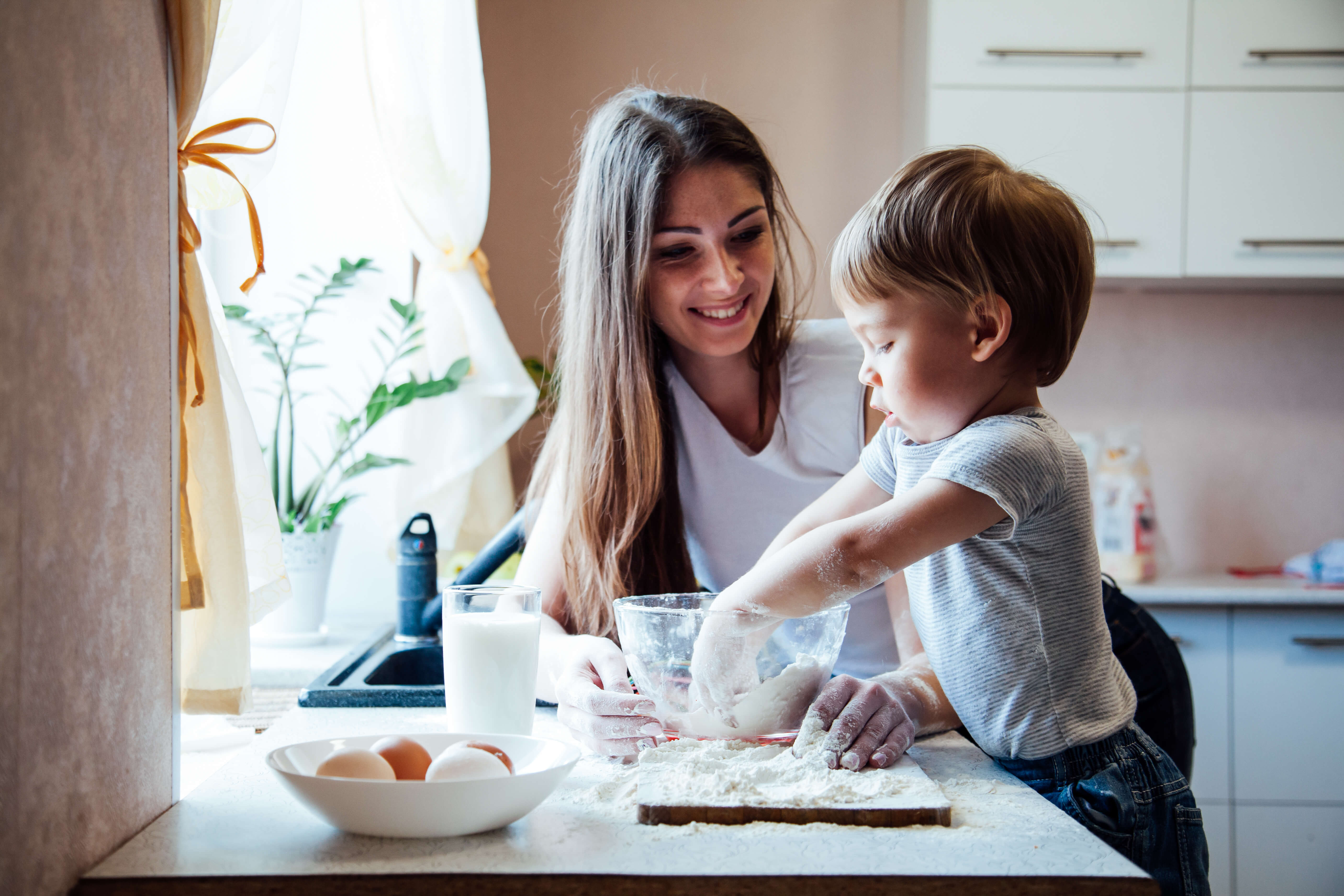 Mother baking in the kitchen with her son