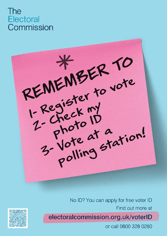 pink post it on blue background with remember to vote written in black marker