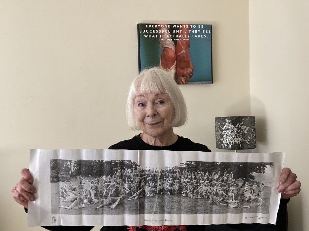 olivia holding up a page with a black and white image