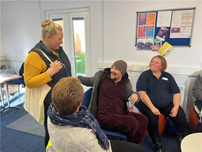 Photo of people talking at a community event Photo of people talking at a community event