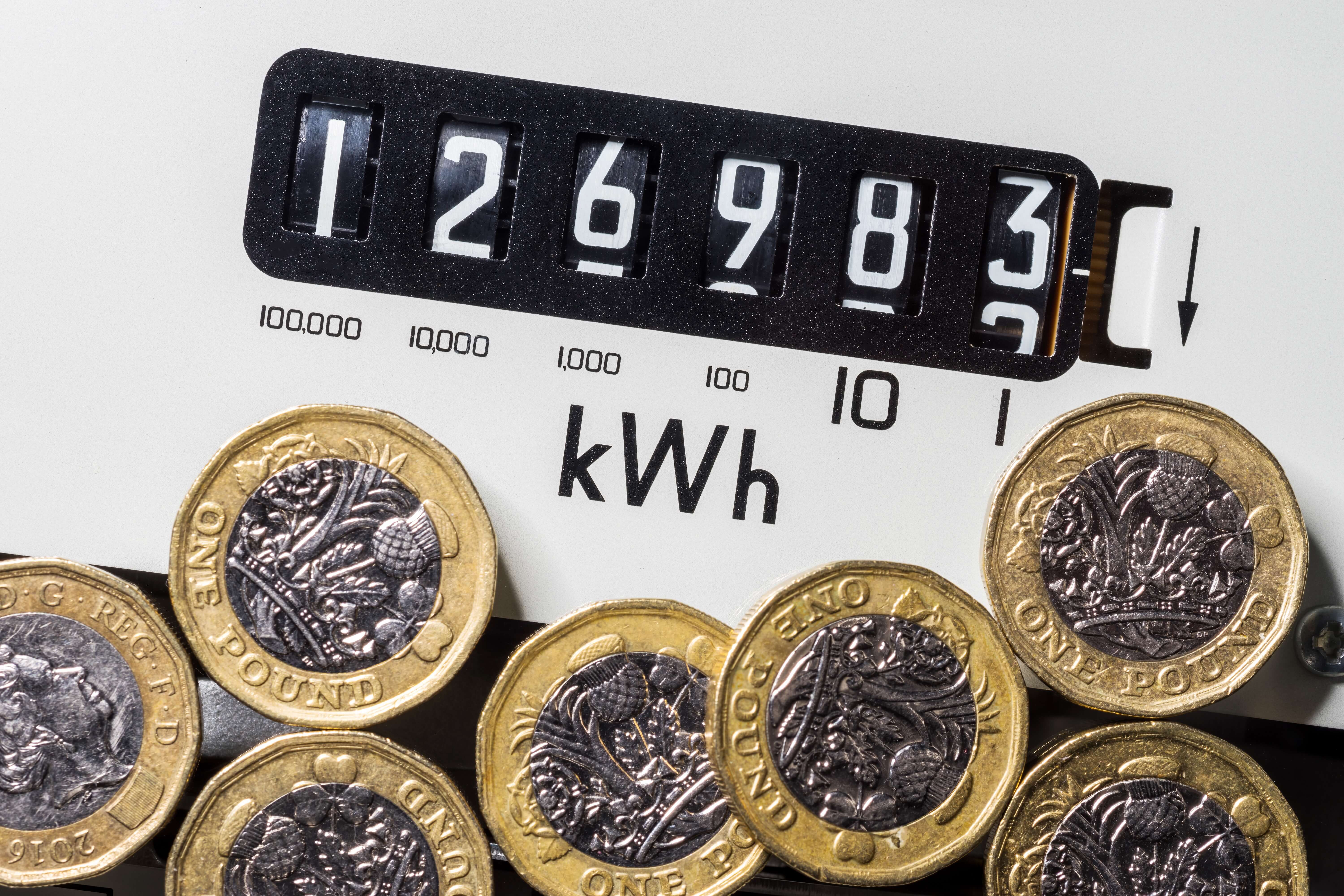 one pound coins placed on top of a white electricity meter one pound coins placed on top of a white electricity meter