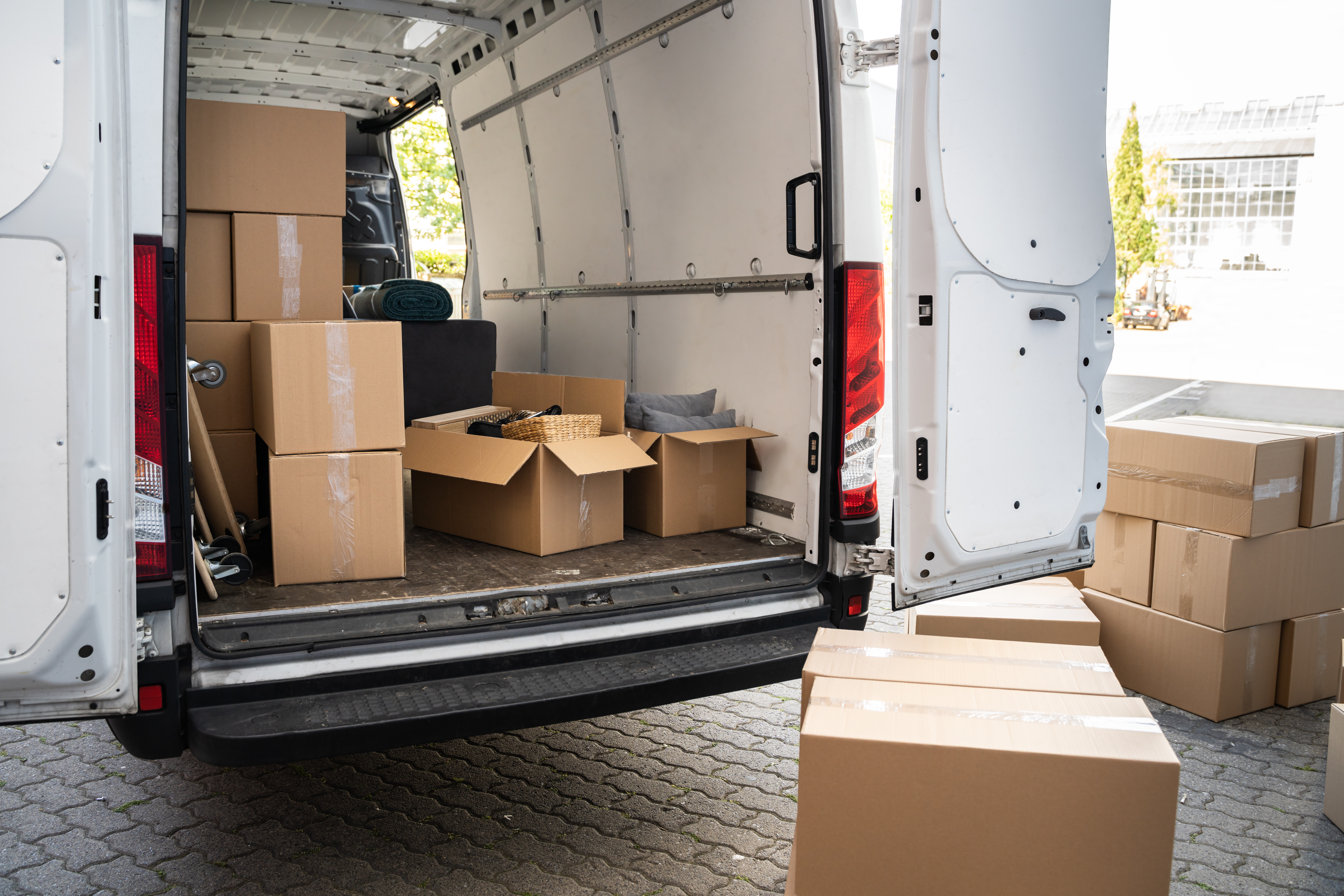 white delivery van with boxes and furniture inside