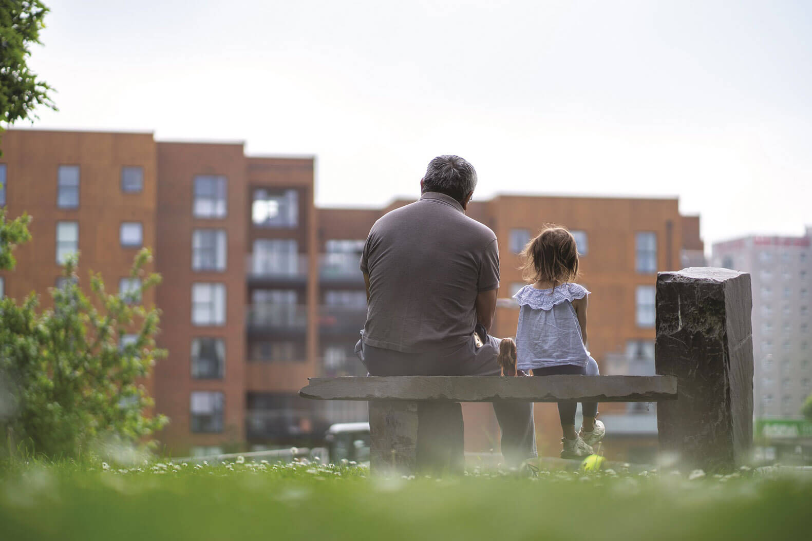 father and child sitting on a bench