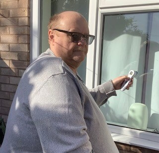 Ron checking heat loss through his window