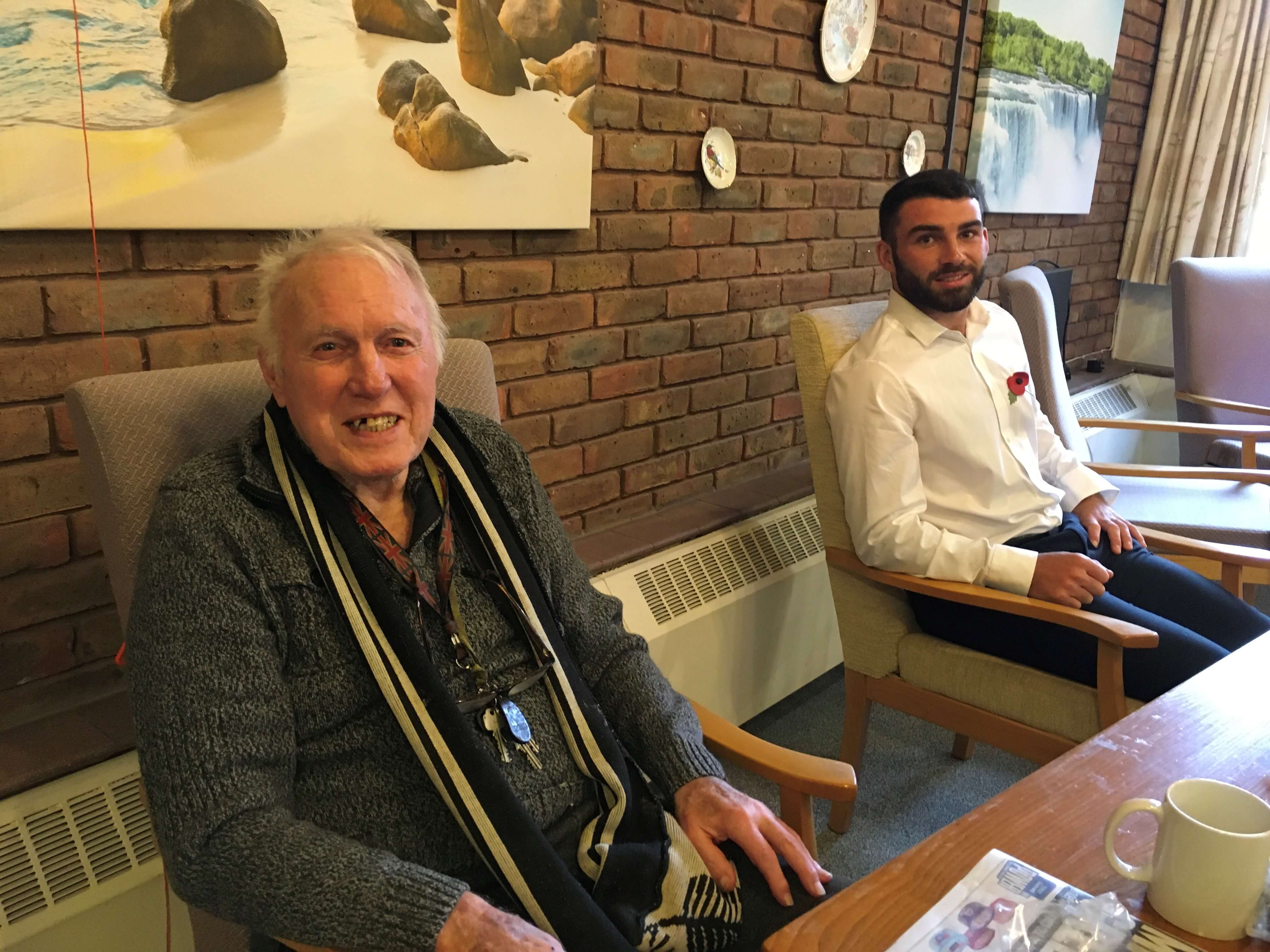 two men named John and David sitting in a lounge two men named John and David sitting in a lounge