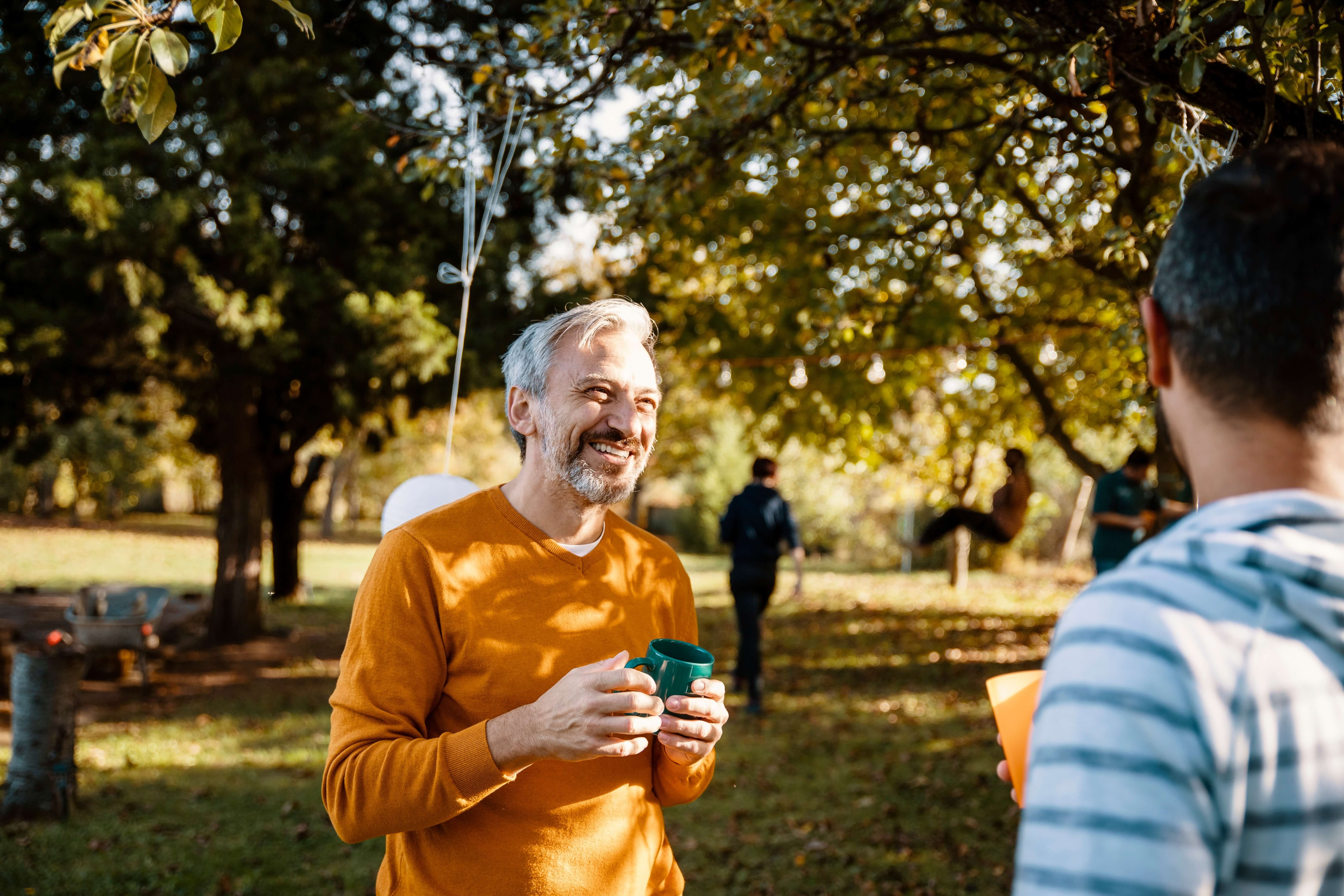 two men in a park talking and laughing