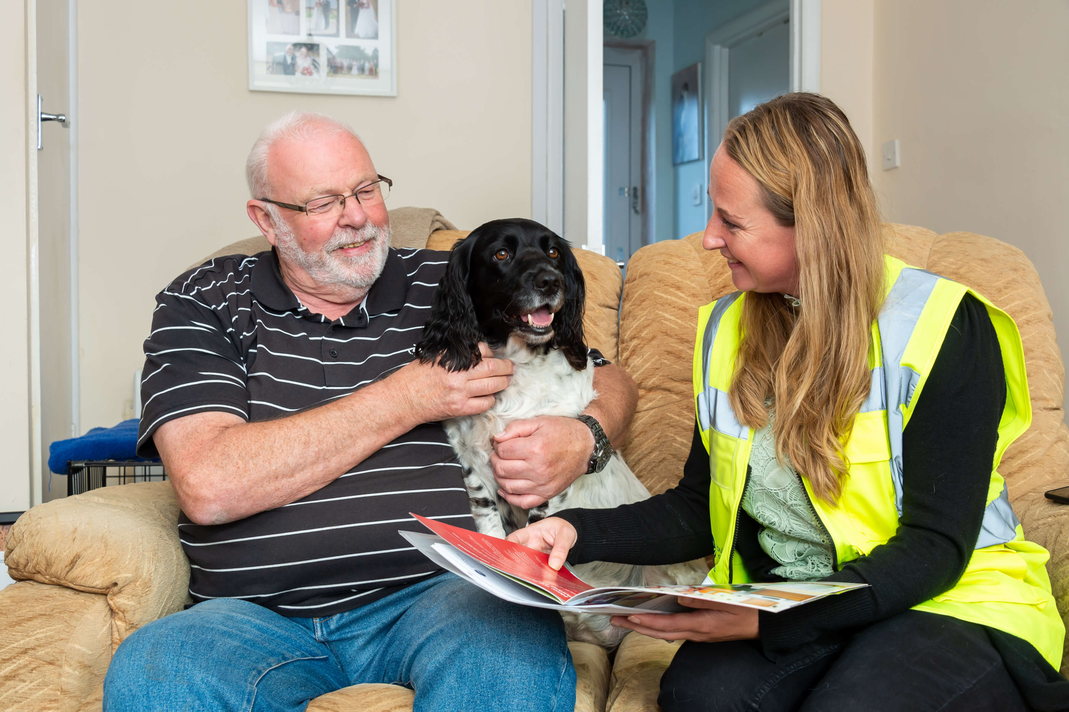 man sitting with his dog talking to a lady
