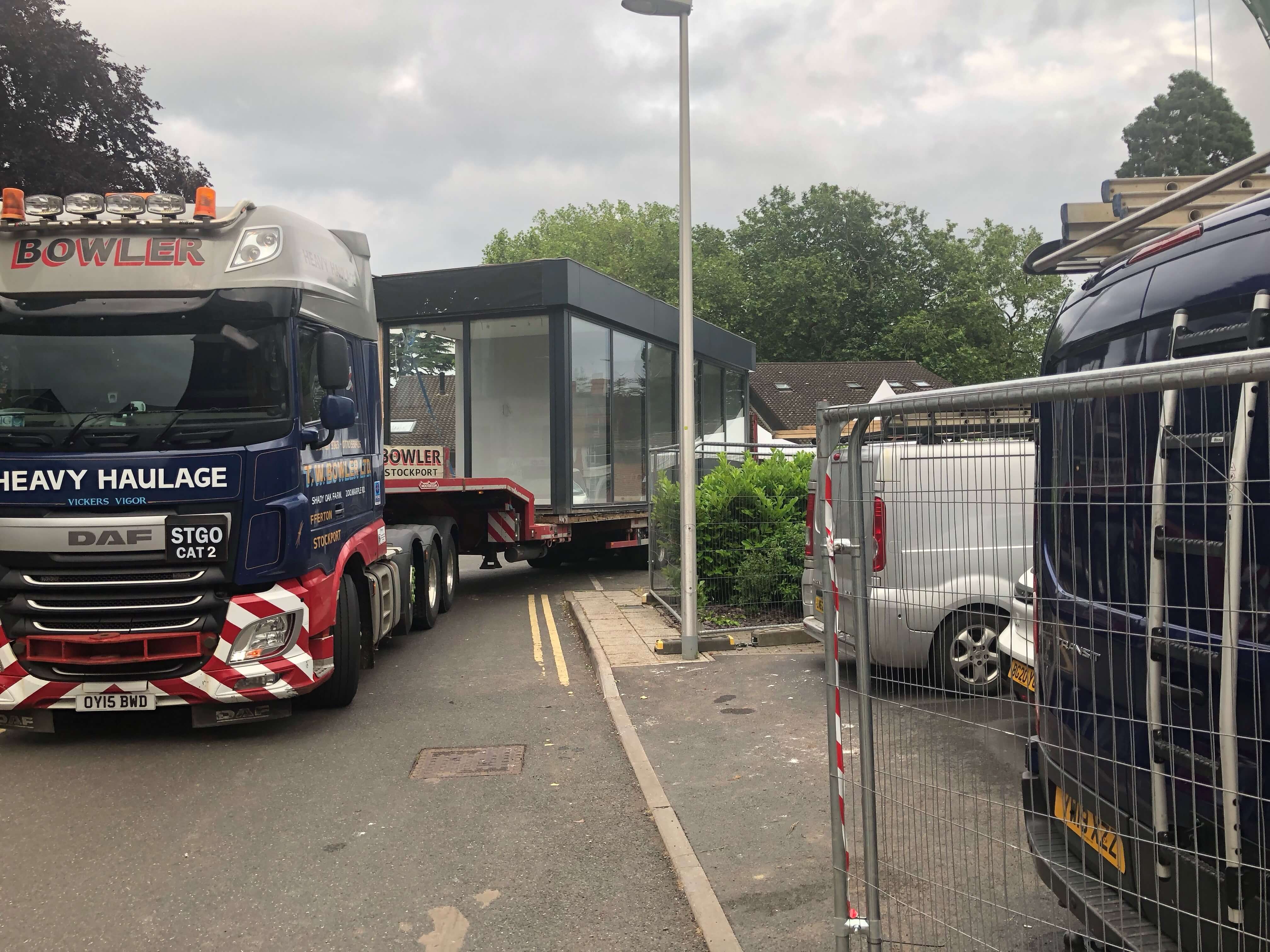 truck in street transporting a glass room truck in street transporting a glass room